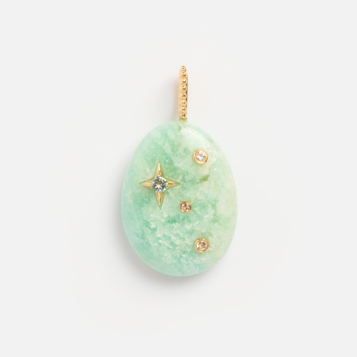 The Solid Gold Zodiac Constellation Crystal Charm features a green oval gemstone with a gold loop, a star-shaped gold setting with a central gem, and two round gems below—an elegant, personalized zodiac jewelry piece.