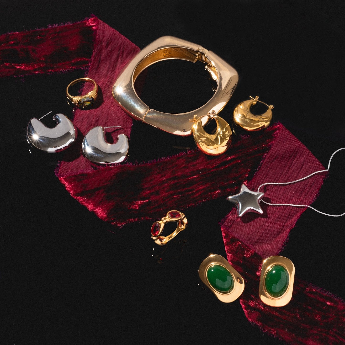 Ashley Earrings, displayed on a black surface with a red velvet ribbon.