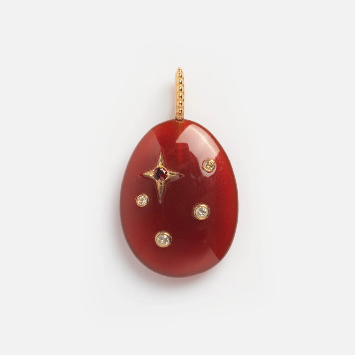 The Solid Gold Zodiac Constellation Crystal Charm features a smooth red oval pendant with a gold beaded loop, a star-shaped gold accent set with a red gem at its center, and four surrounding round crystals—ideal as personalized zodiac jewelry.