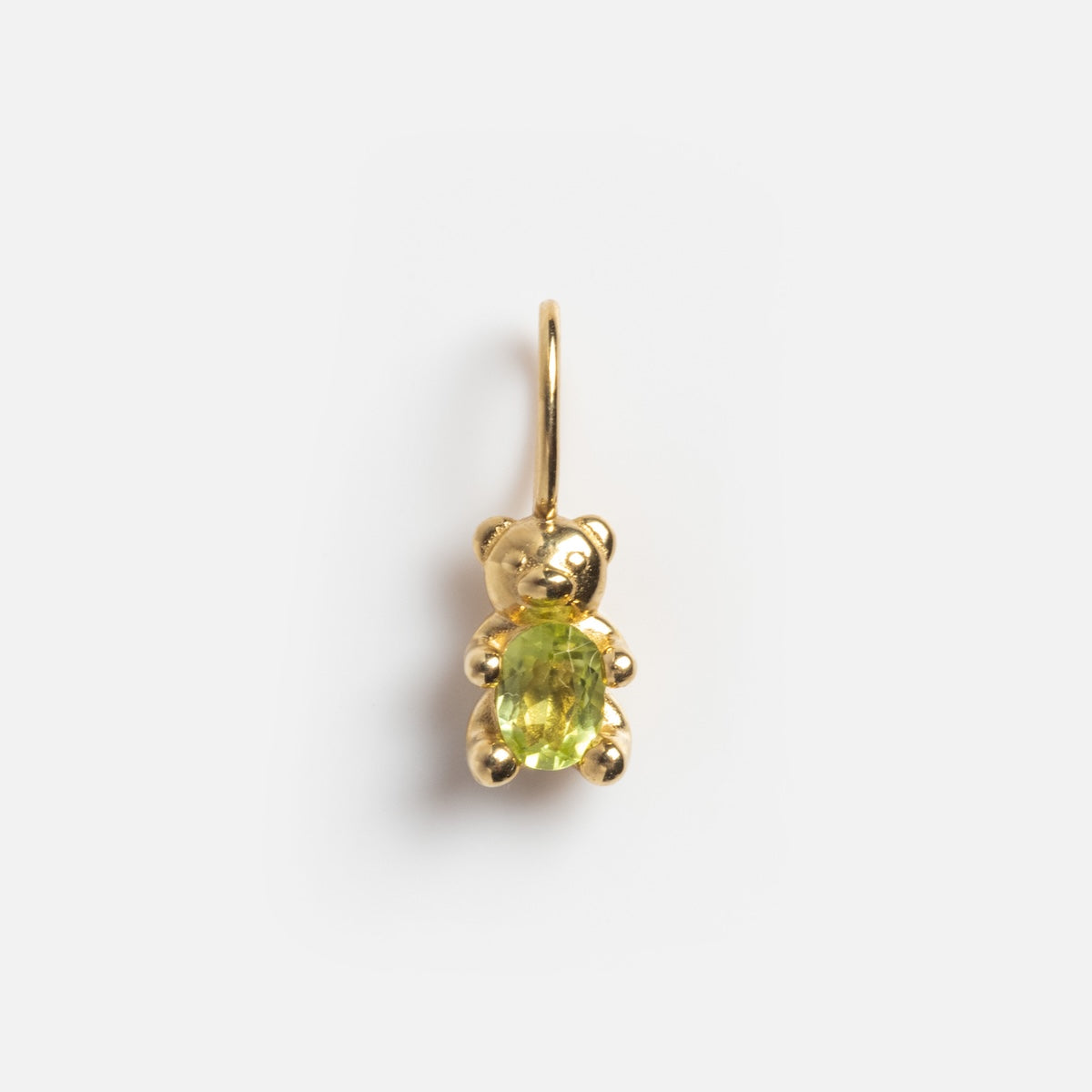 The Solid Gold Foodie Charm is a teddy bear-shaped pendant crafted from 9k solid yellow gold with a green oval gemstone in its belly, ideal as a charm necklace, shown on a plain white background.