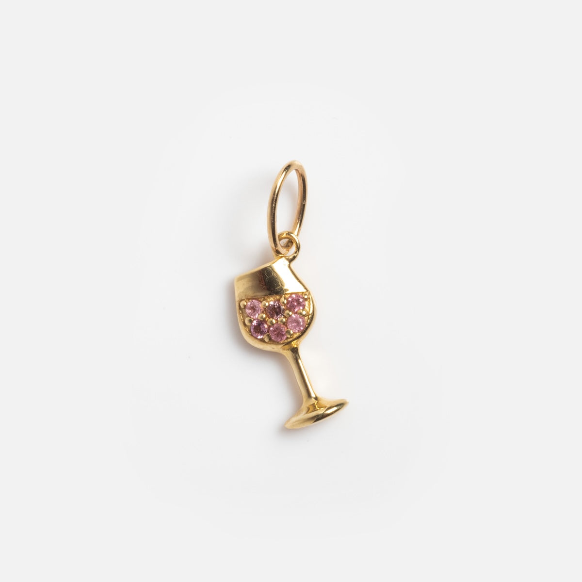 The Solid Gold Foodie Charm is a 9k yellow gold wine glass charm with pink gemstones, attached to a small loop, shown on a white background—ideal for pairing with solid gold charms or adding to a fruit charm necklace.