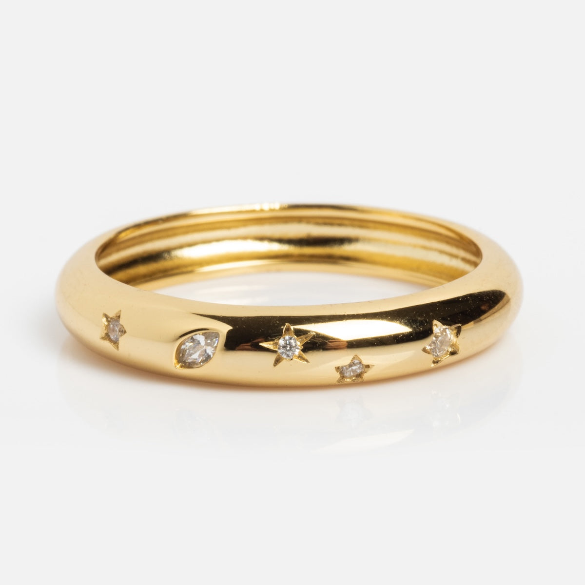 The Star Crossed Celestial Dome Ring features a smooth, polished 14k gold vermeil dome adorned with a marquise diamond and four CZ star accents.