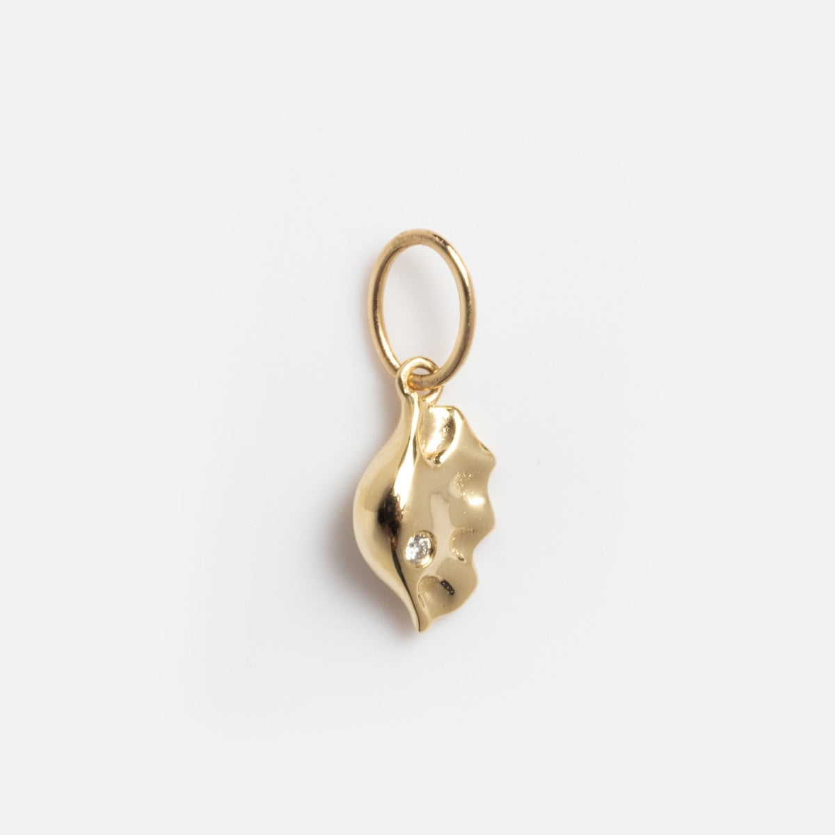 The Solid Gold Foodie Charm is a small 9k yellow gold seashell-shaped pendant with a hanging loop, shown on a plain white background—perfect for pairing with other solid gold charms or your favorite fruit charm necklace.