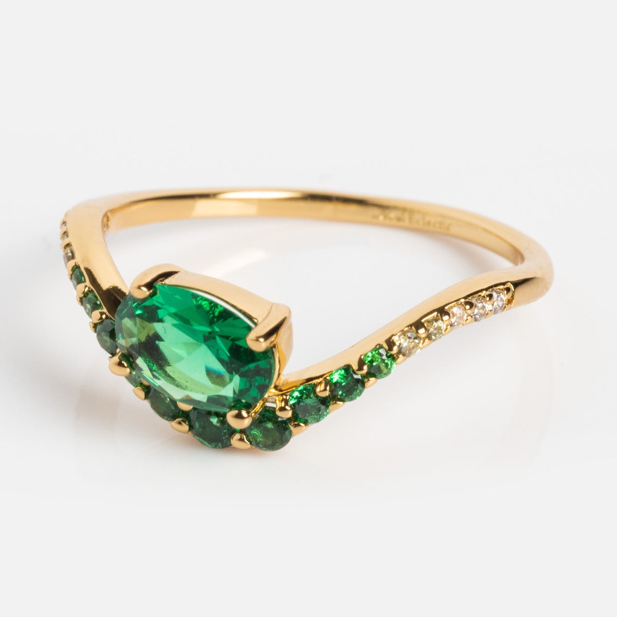 The Main Character Floating Ombre Birthstone Ring features an oval green center gemstone with smaller green and clear stones on the band, shown on a plain white background.