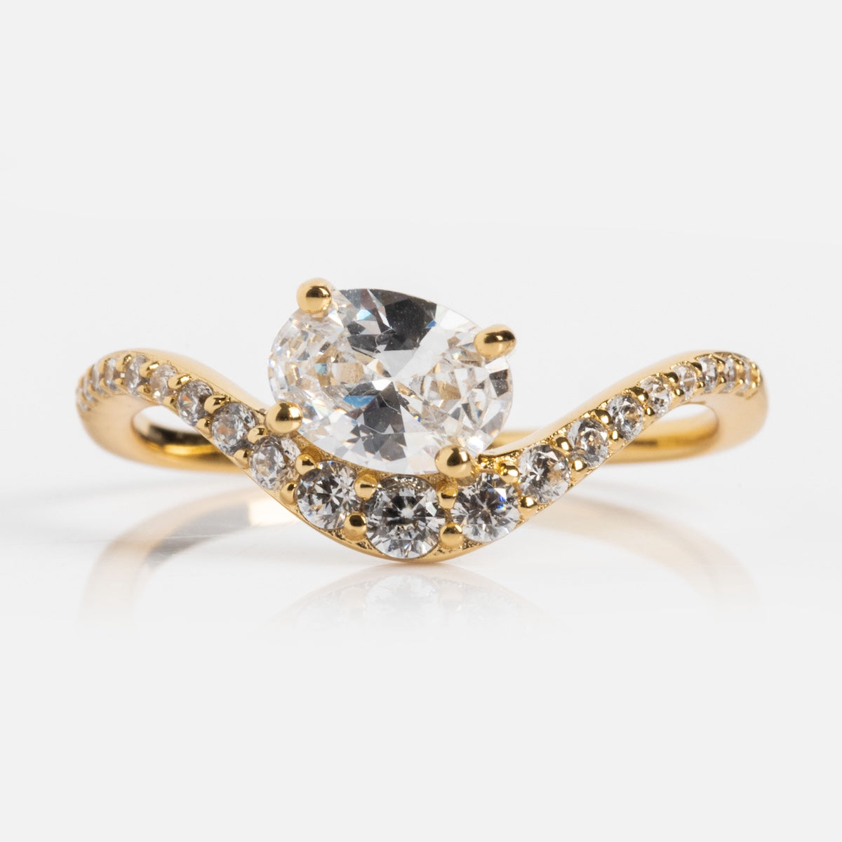 The Main Character Floating Ombre Birthstone Ring features a wavy gold band with small diamonds, an oval-cut center diamond, and two round side diamonds, all displayed against a white background.