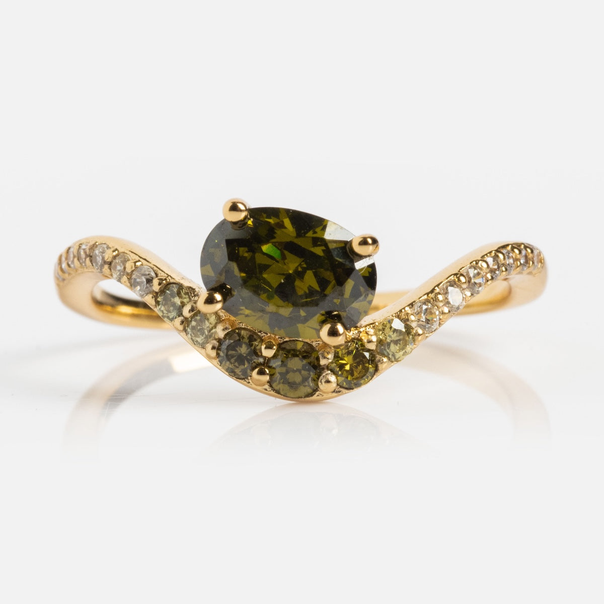 The Main Character Floating Ombre Birthstone Ring showcases an oval green gemstone at the center, accented by smaller green stones and white diamonds on a wavy gold band—a striking piece of elegant birthstone jewelry.