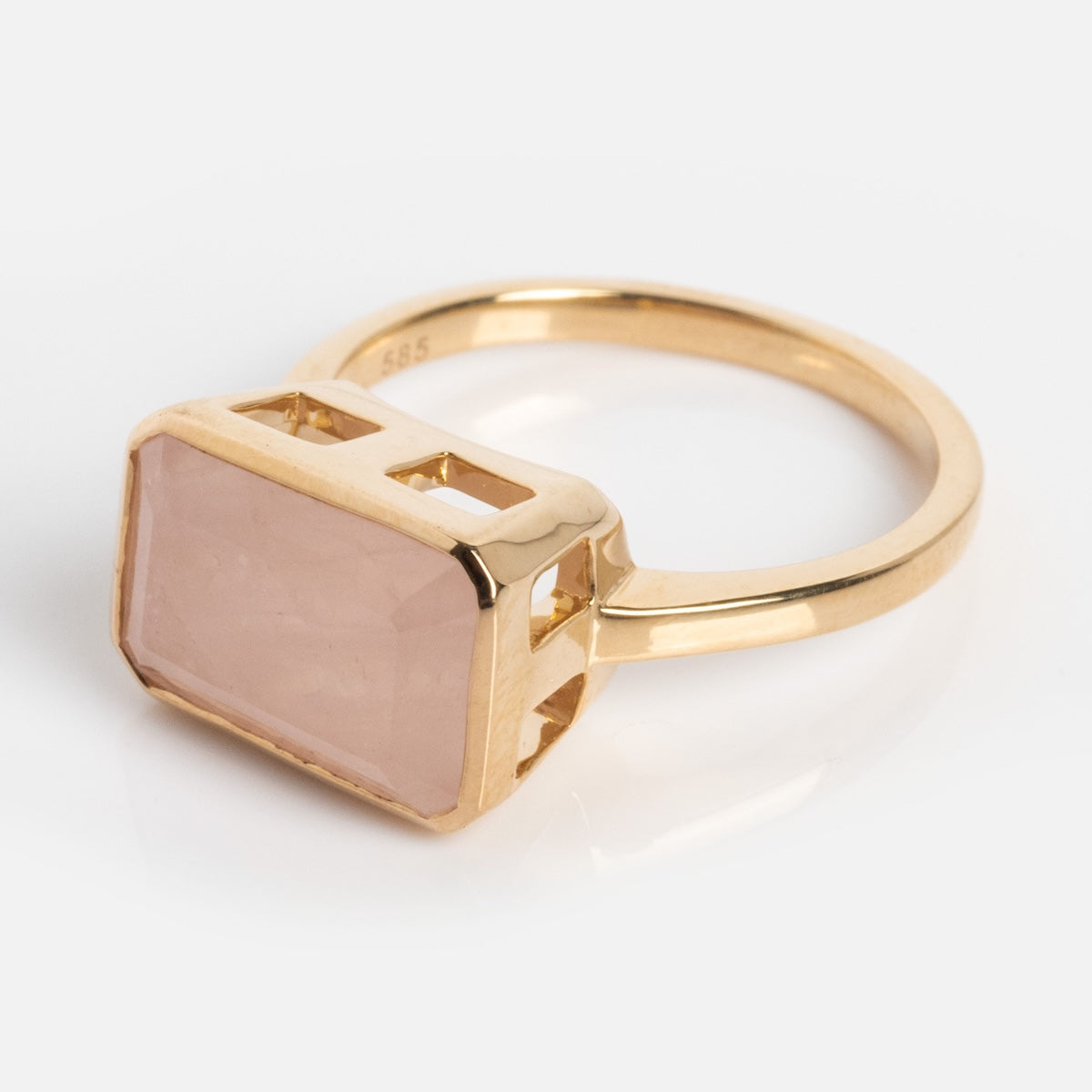 A modern heirloom, the 14k Jojo Ring features a rectangular, faceted rose quartz gemstone set in solid yellow gold with an open-sided bezel setting.