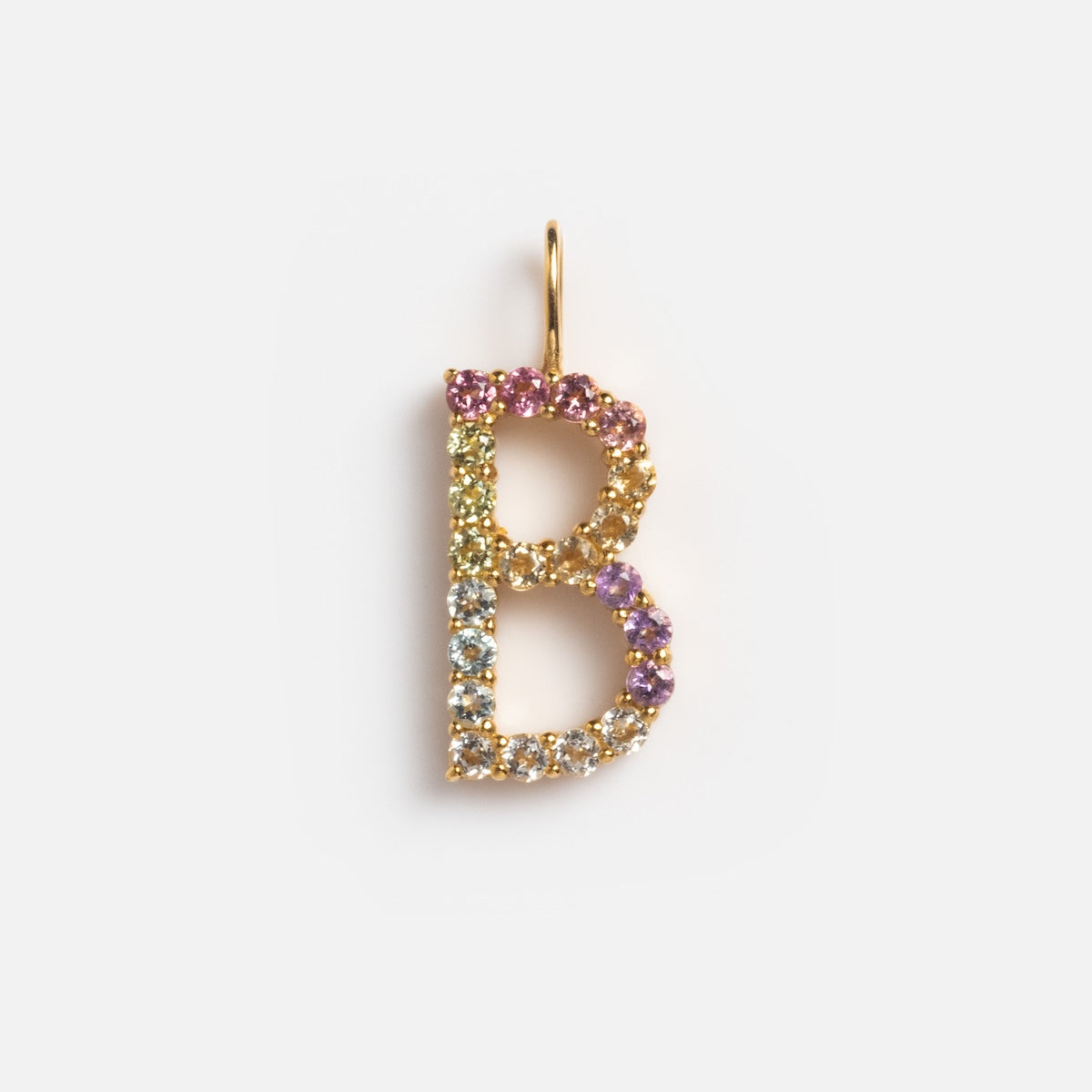 The Solid Gold Pastel Gemstone Letter Charm Sample features a gold letter B pendant, crafted from 9k solid yellow gold and adorned with purple, yellow, light blue, and pink tourmaline gemstones against a plain white background.