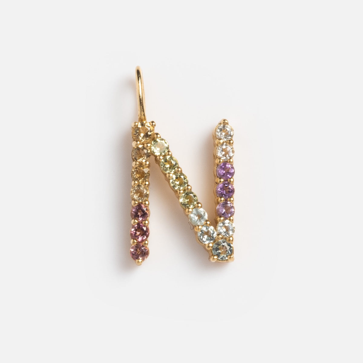 Solid Gold Pastel Gemstone Letter Charm Sample: gold letter N pendant with multi-colored gemstones like pink tourmaline, set in 9k yellow gold, shown on a plain white background.