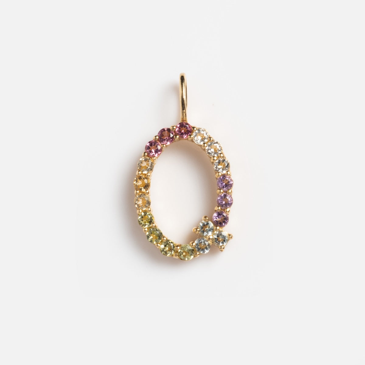 The Solid Gold Pastel Gemstone Letter Charm Sample is a Q-shaped pendant crafted in 9k yellow gold and set with pastel multicolored gemstones, including pink tourmaline, displayed on a plain white background.