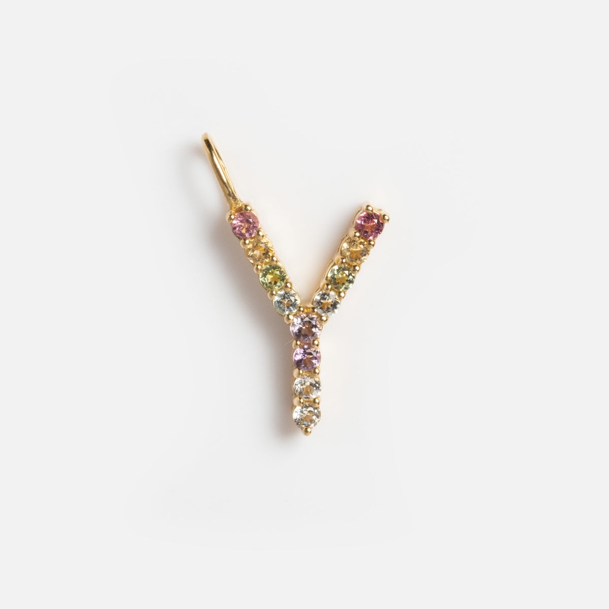 The Solid Gold Pastel Gemstone Letter Charm Sample features a 9k yellow gold pendant shaped as the letter Y, adorned with small multicolored gemstones, and is shown against a plain white background.