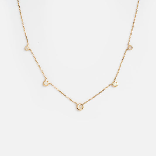 The Solid Gold Horizon Moonstone and Opal Sprinkle Necklace features five small, evenly spaced circular pendants, displayed against a plain white background.