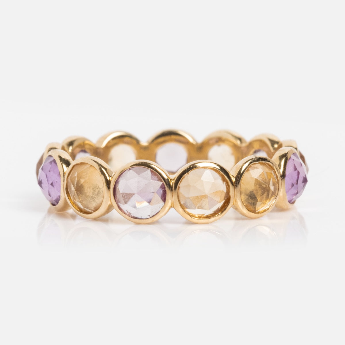 A Solid Gold Sunrise Citrine and Alexandrite Band featuring alternating round citrine and alexandrite gemstones in bezel settings, displayed against a white background.