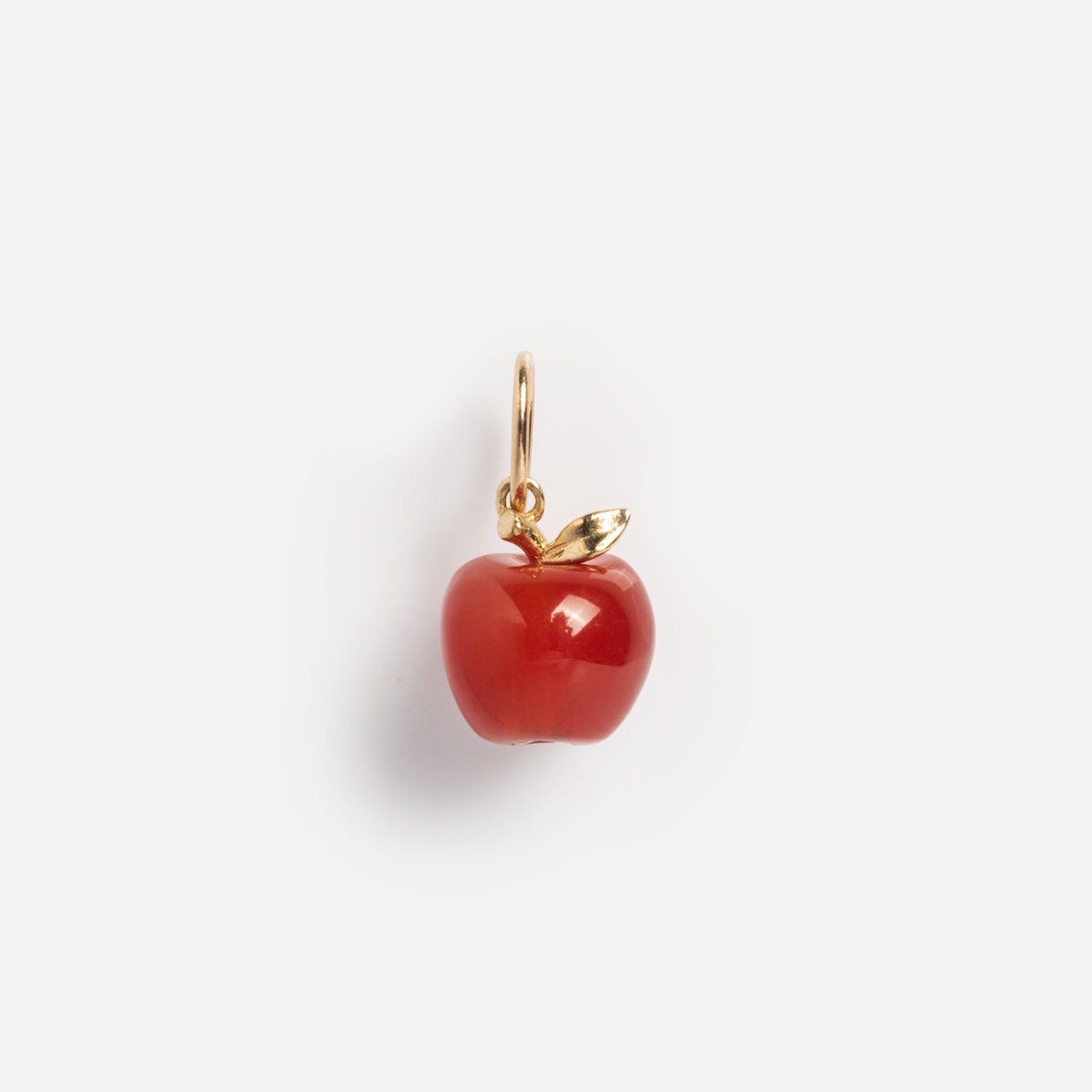 The Solid Gold Foodie Charm is a 9k yellow gold red apple charm with a gold stem and leaf—ideal for adding a playful accent to your fruit charm necklace. Shown on a plain white background.