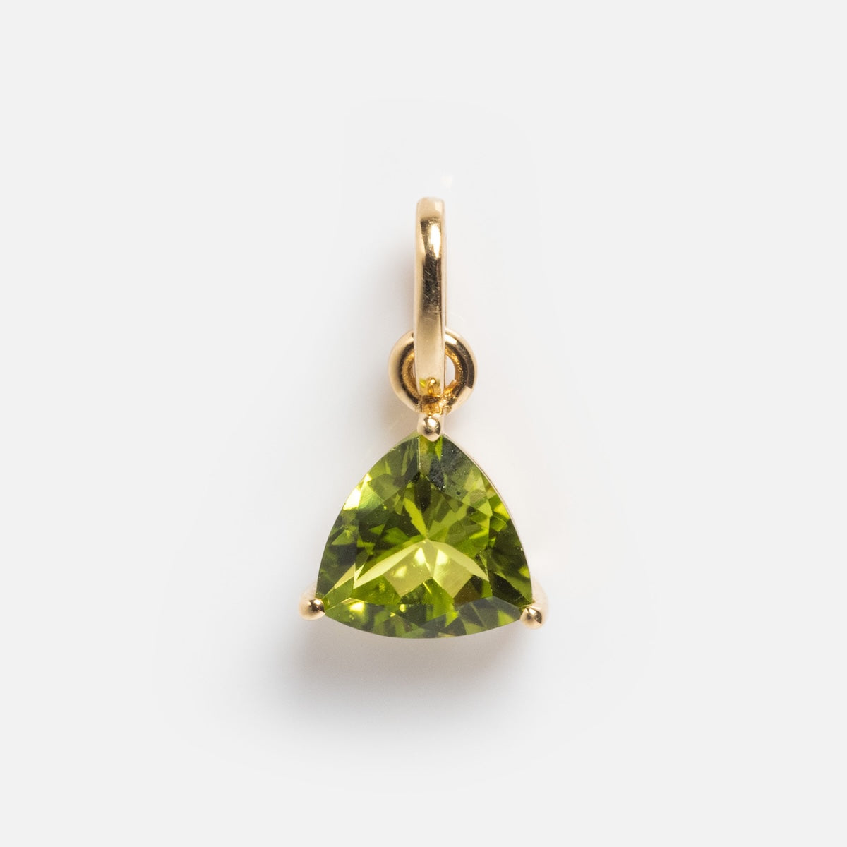 The Solid Gold Trillion Birthstone Charm showcases a trillion-cut birthstone, likely peridot, set in minimalist three-prong 9k yellow gold and shown on a plain white background.