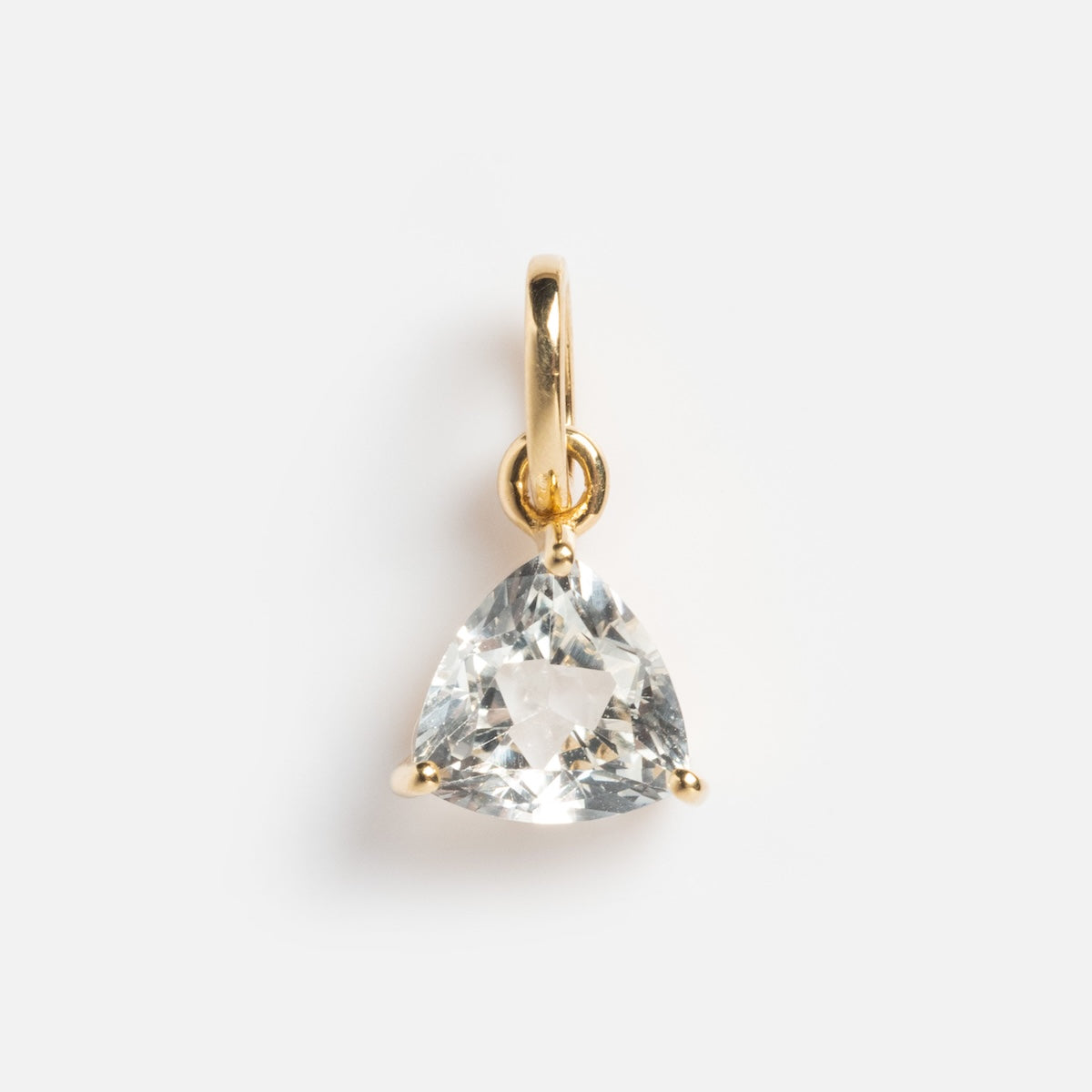 The Solid Gold Trillion Birthstone Charm is a 9k yellow gold pendant with a trillion cut birthstone set in three prongs, shown on a plain white background.