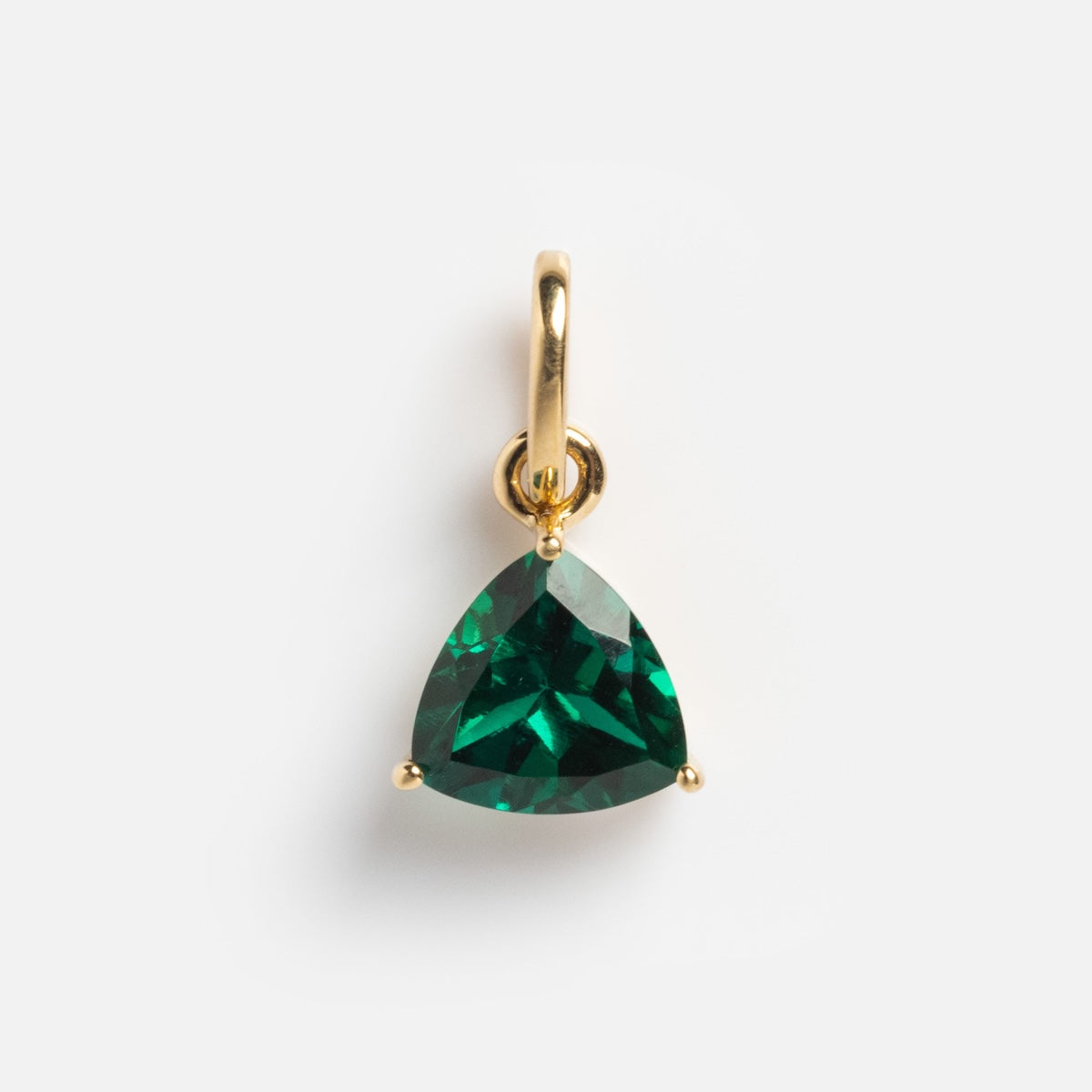 The Solid Gold Trillion Birthstone Charm is crafted in 9k yellow gold with a trillion cut birthstone held by three prongs, shown on a plain white background.