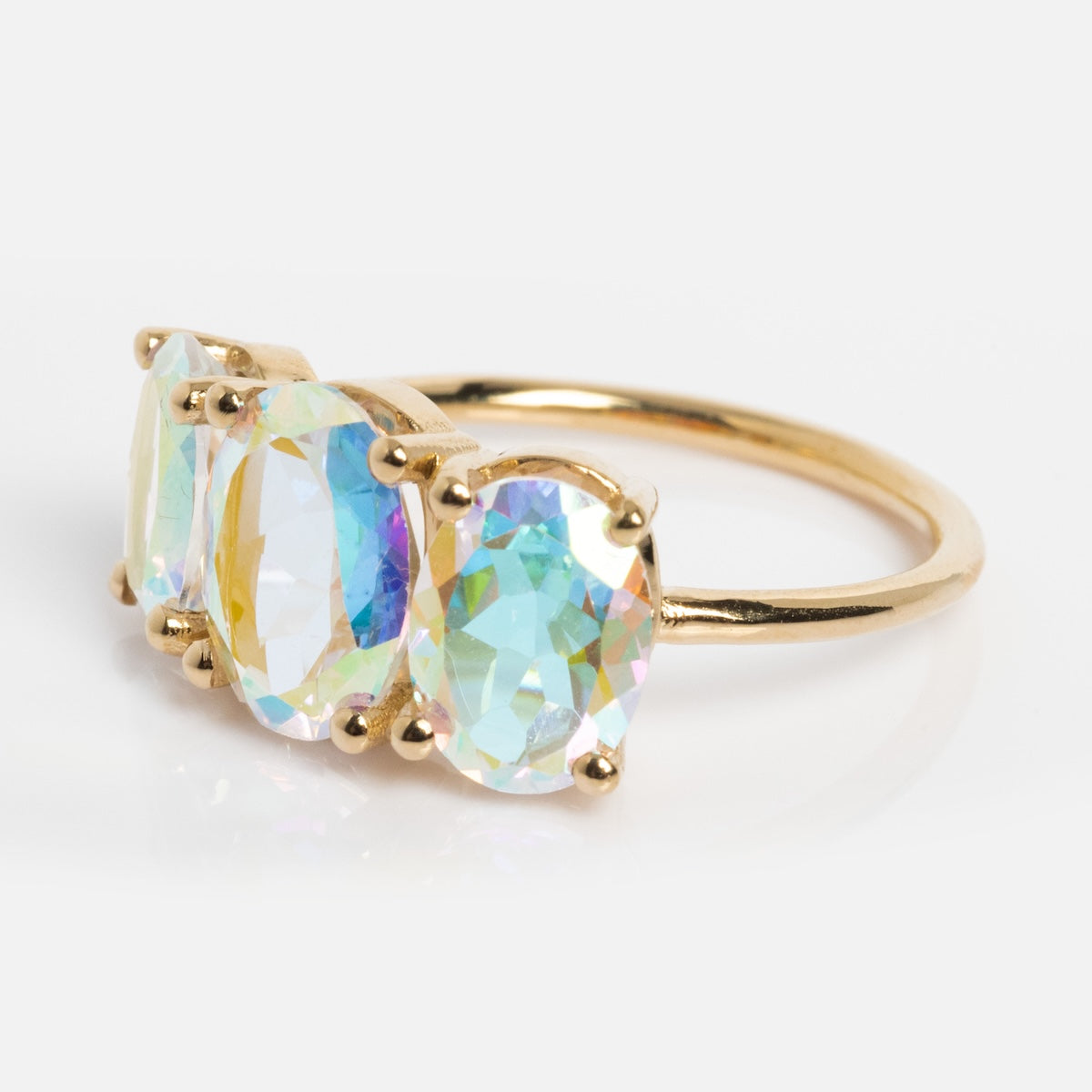 The One of a Kind 14k Angel Aura Gumdrop Ring showcases three large oval iridescent gemstones set in prongs on a white background—a unique statement piece in fine jewelry.