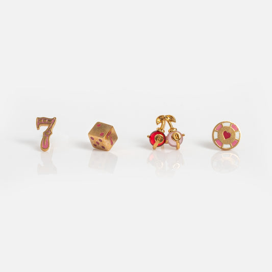 The Feeling Lucky Stud Set features four small gold pins—a red-and-gold number seven, a gold die with red dots, gold cherries, and a casino poker chip—displayed on a plain white background, perfect for your own lucky ear stack.