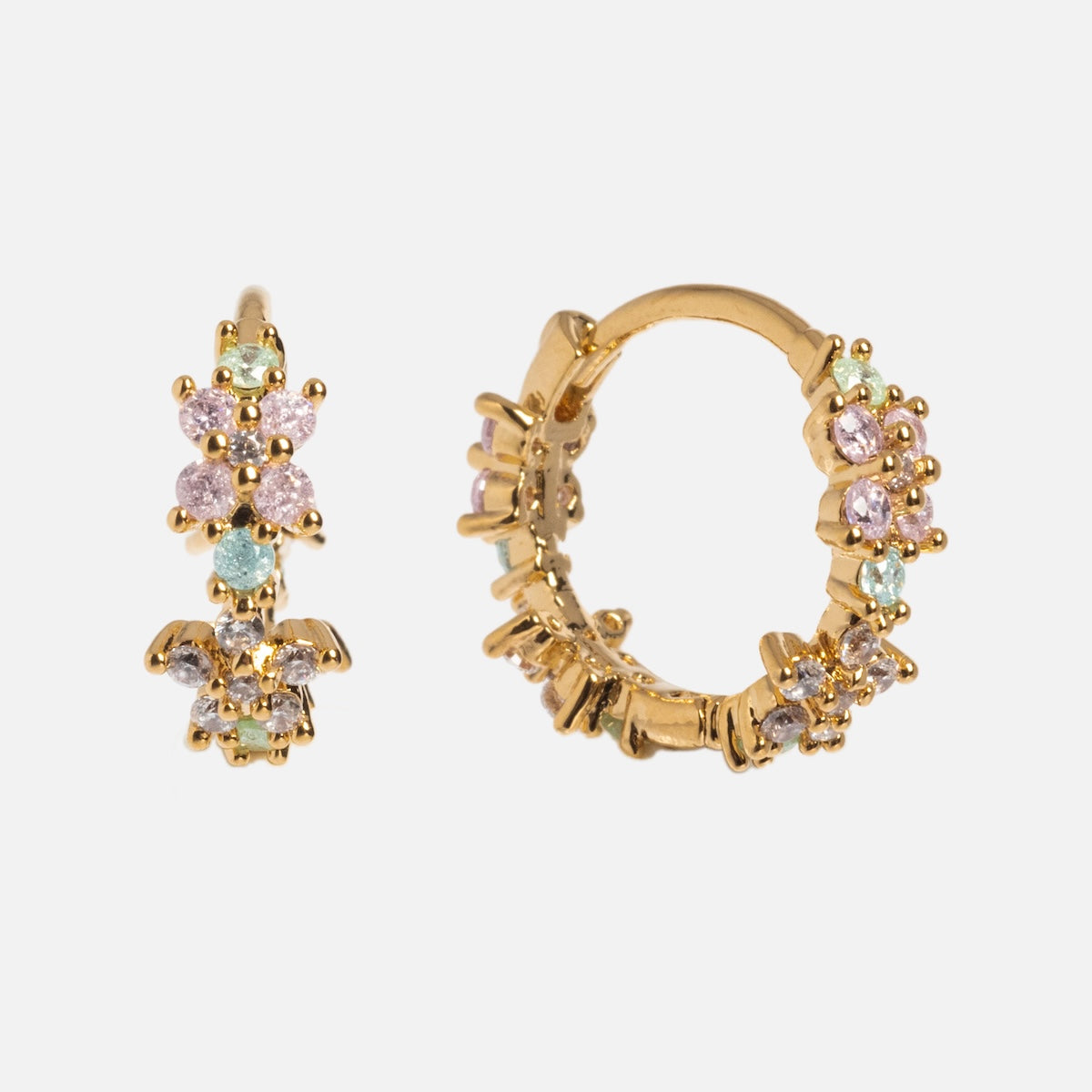 The Pastel Star Huggie Hoops are small gold-plated earrings featuring clusters of pastel pink, green, and blue gemstones that add sparkle against a plain white background.