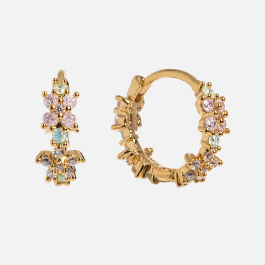 The Pastel Star Huggie Hoops are small gold-plated earrings featuring clusters of pastel pink, green, and blue gemstones that add sparkle against a plain white background.