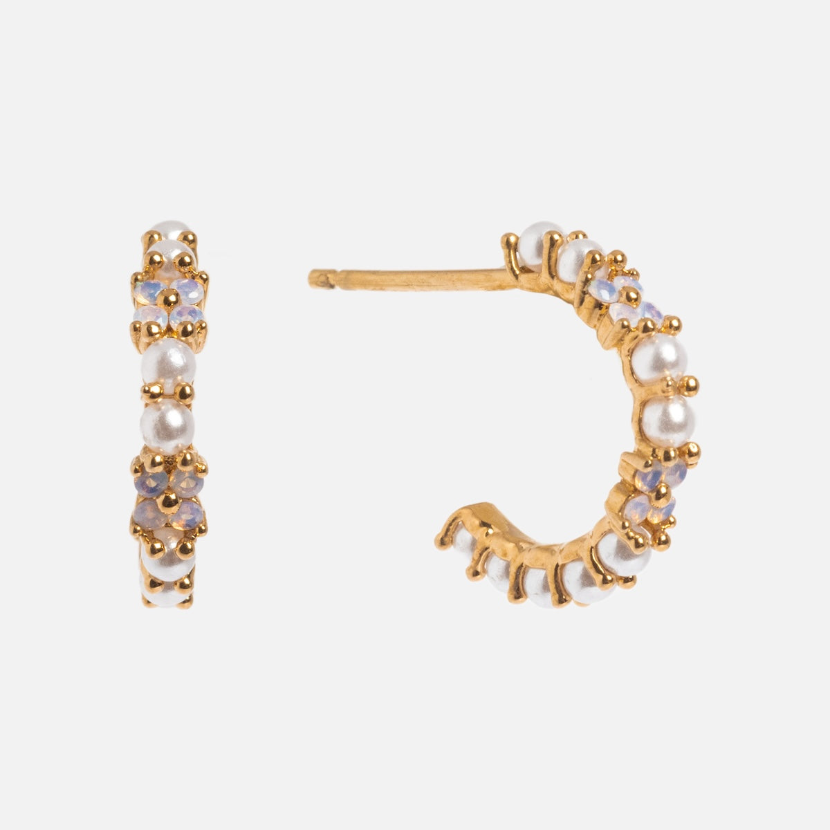 The Orchid Pearl Hoops are small gold-plated earrings with white pearls and light purple gemstones in a delicate gold frame, displayed from front and side angles on a white background.
