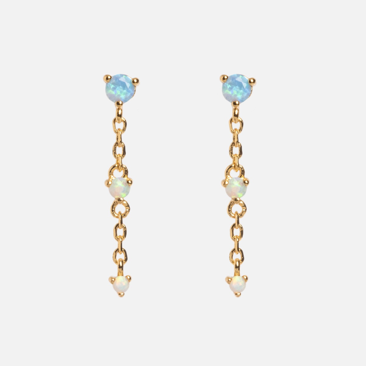 The Celebration Ombre Birthstone Drop Studs are 14k gold-plated chain drop earrings with three small, round opal gemstones on each earring, spaced along the chain and shown on a plain white background.