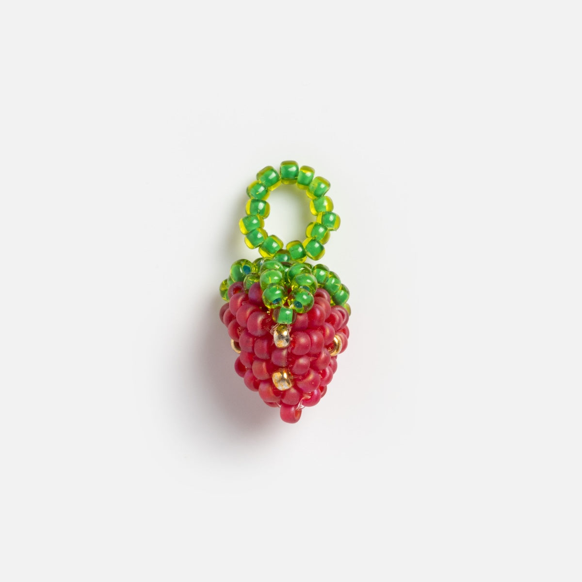 The Beaded Charm is a small, strawberry-shaped accessory made with red beads for the berry and green beads for the leafy top and loop, ideal for a charm necklace by Tai Jewelry. Shown against a plain white background.