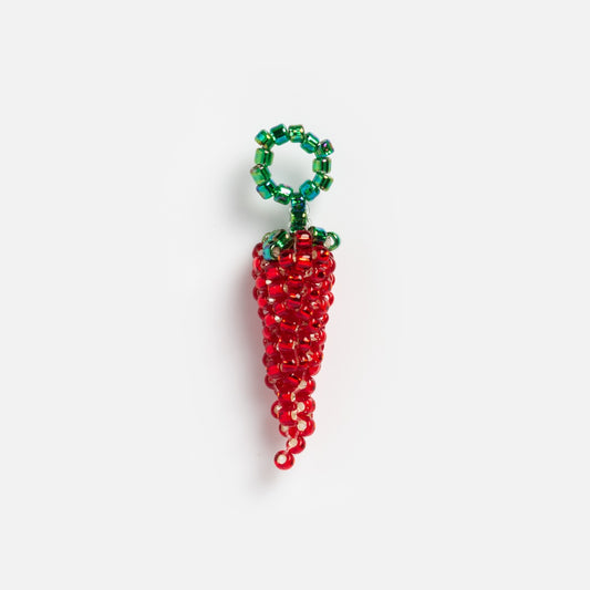 The Beaded Charm is a small keychain shaped like a red chili pepper, made from red and green beads, with a top loop for attachment. It can also be used as a charm necklace and is displayed against a plain white background.