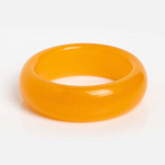 The Orange Quartzite Ring features a chunky, glossy design with a smooth, rounded surface—ideal for bold stacking. Displayed against a plain white background, it’s the perfect statement piece.
