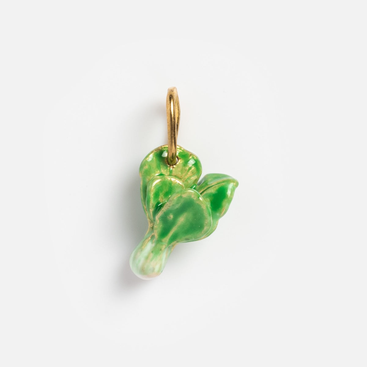 A glossy enamel charm from Charms by Satomi Studio, shaped like a leafy green vegetable with a gold loop for attaching to necklaces or bracelets, shown on a plain white background.