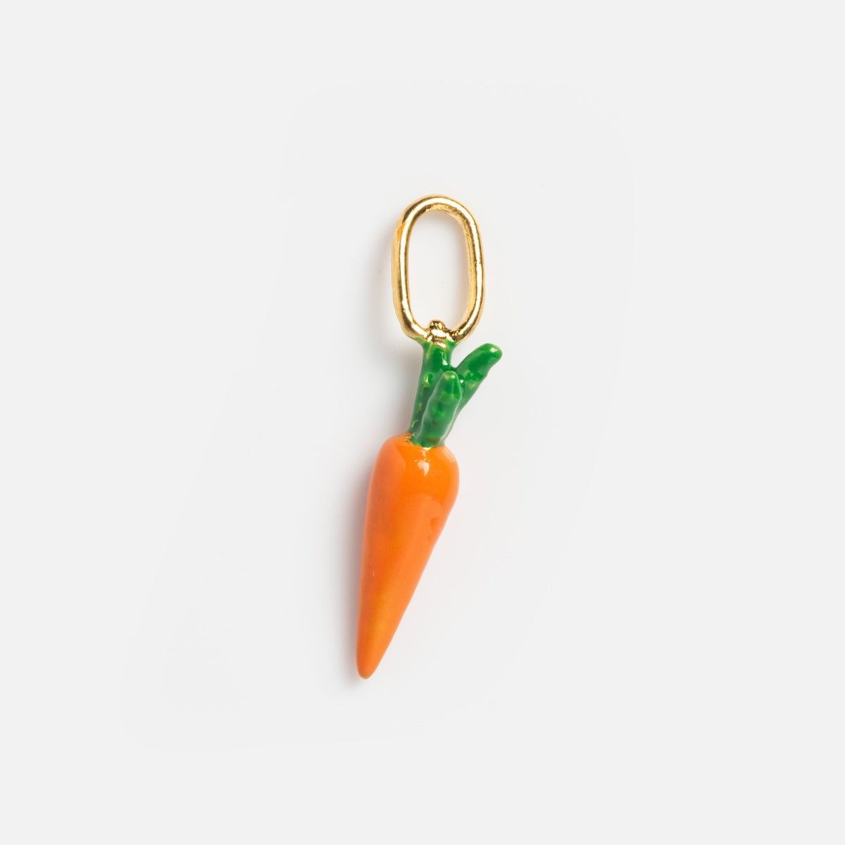 The Charms by Satomi Studio features a small orange carrot charm with green leaves and a gold loop, ideal for enamel jewelry or adding a playful touch to your necklace, displayed on a plain white background.