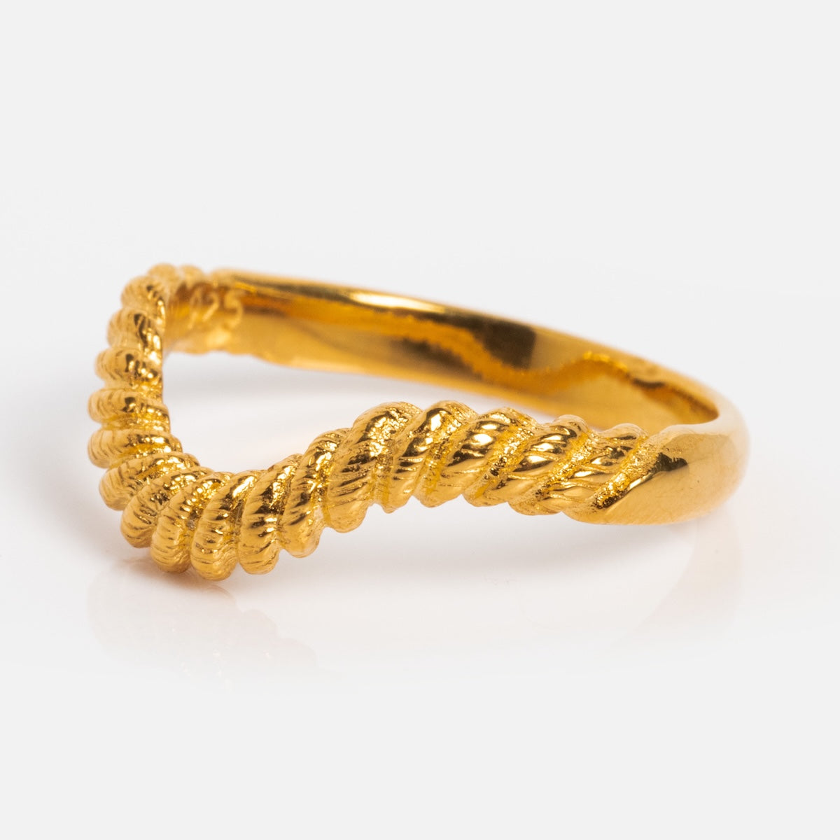 The Curved Rope Ring is a stacking ring crafted in 18k gold vermeil, featuring a twisted rope design on one side, shown on a plain white background.