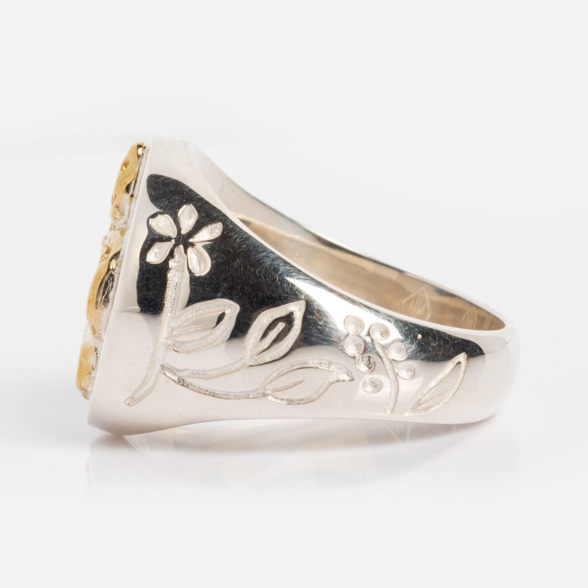 The Serpent Signet Ring, crafted in sterling silver and featuring detailed serpent engravings on the band, is showcased against a plain white background.