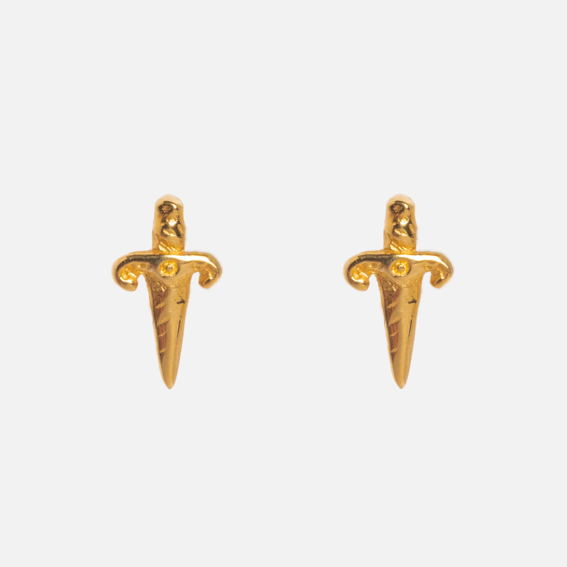 The Mini Dagger Stud Earrings by Hunt of Hounds, crafted in gold vermeil with textured handles and pointed blades, are shown on a plain white background.