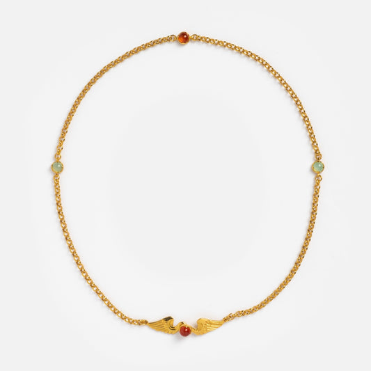 The Astral Necklace is a delicate 18k gold vermeil chain with two small wing-shaped charms at the center, accented by a carnelian stone and two smaller colored stones spaced equally along the chain.