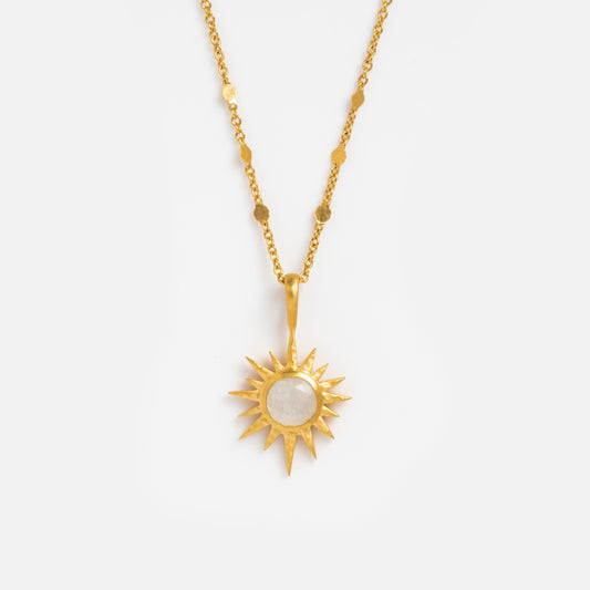 The Moonstone North Star Necklace is an 18k gold plated piece featuring a sun-shaped pendant with a round, moonstone-like center, shown on a plain white background.