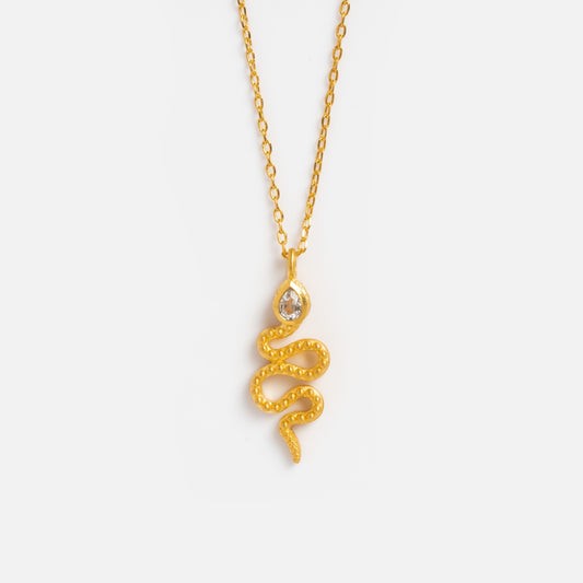 The White Topaz Dot Snake Pendant Necklace by Satya Jewelry features a gold coiled snake and a teardrop-shaped white topaz gemstone above the pendant.