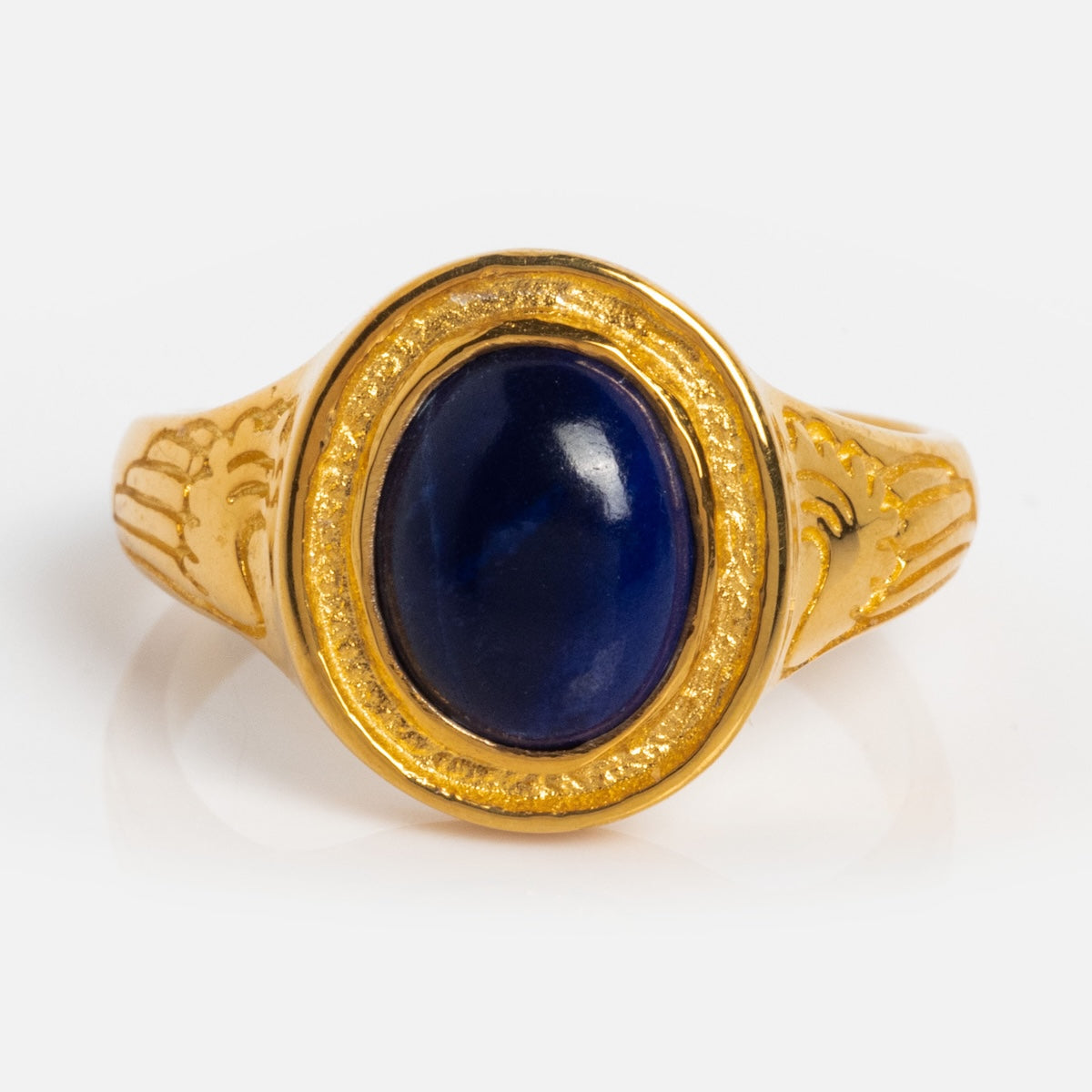 The Astral Ring is a gold vermeil band engraved with wings, highlighted by an oval deep blue lapis stone set at its center.