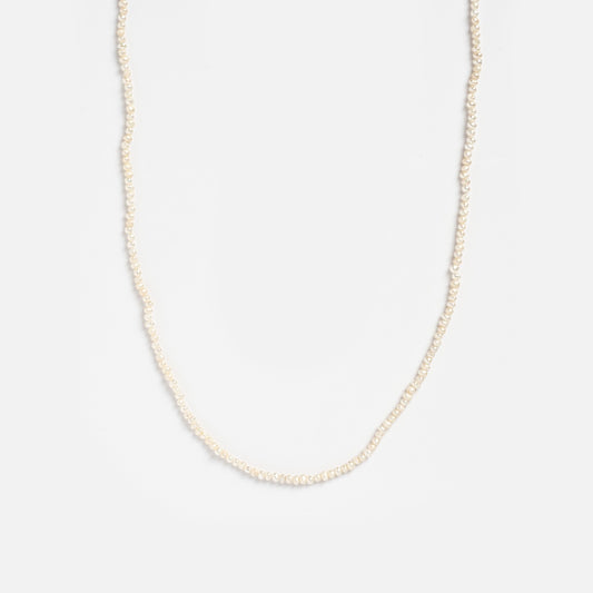 The Vermeil Delicate Pearl Chain features small, evenly spaced white pearls in a single strand, showcased against a plain white background.