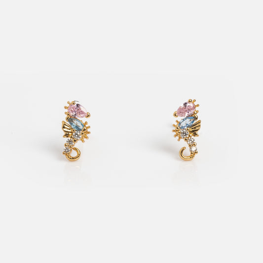 The Whimsical Sea Horse Studs are gold plated earrings adorned with sparkling gemstones, perfect for adding a playful, elegant touch to any look.