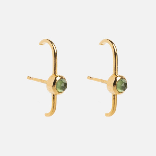 Dillon Studs: 14k gold plated earrings featuring a small green gemstone and an open curved design, shown on a plain white background.