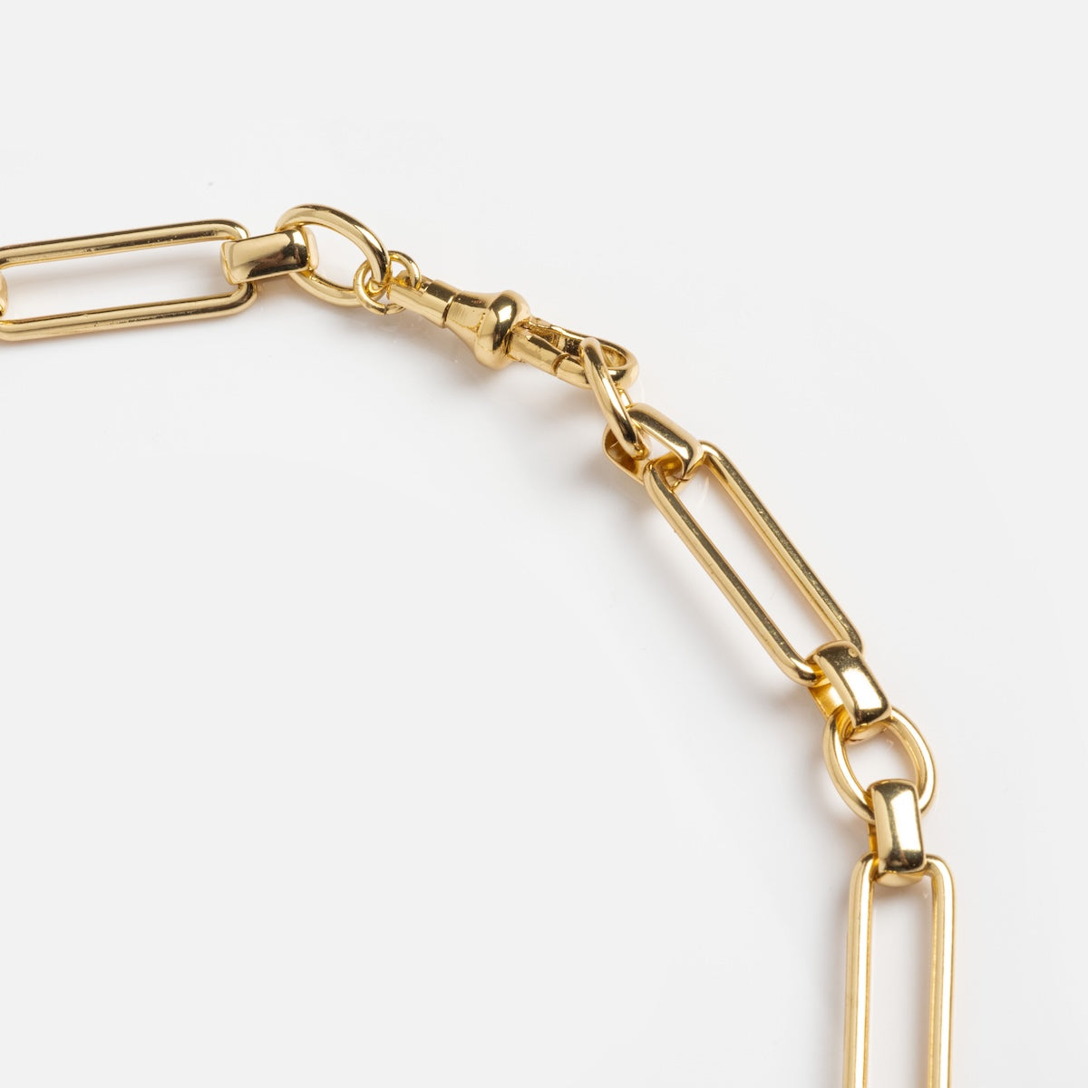 Close-up of the Constance Necklace, an 18k gold plated piece with elongated rectangular links and a lobster clasp, displayed on a plain white background—a bold modern accessory for any occasion.