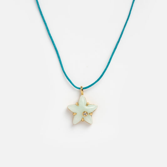 Star-shaped pendant necklace on a white background