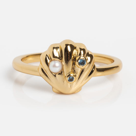 Gold ring with a shell design featuring a pearl and gemstones on a white background