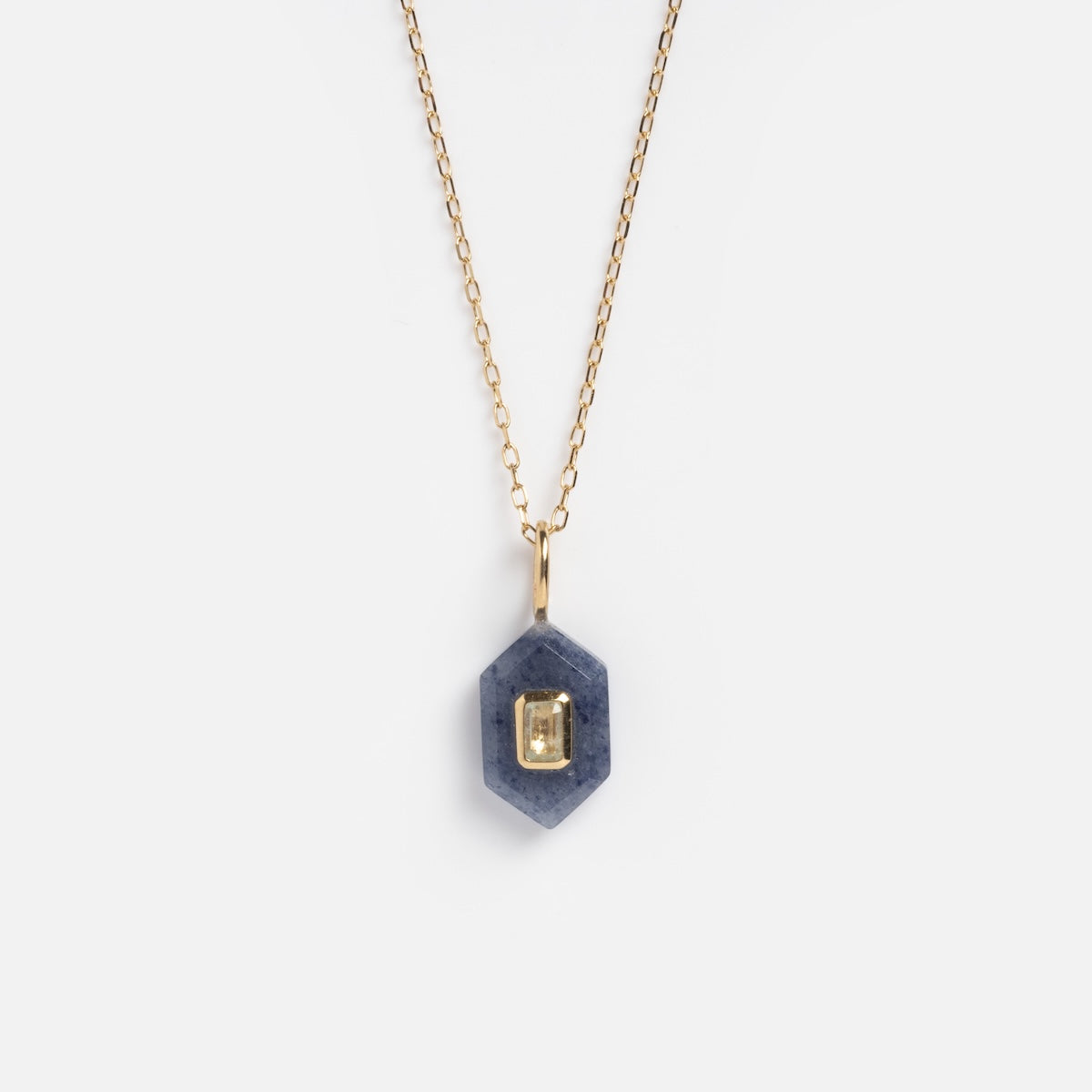 The Solid Gold Aura Necklace Blue Sample features a gold chain and a hexagonal Blue Aventurine pendant with a rectangular 9k solid yellow gold accent at its center, shown on a white background.