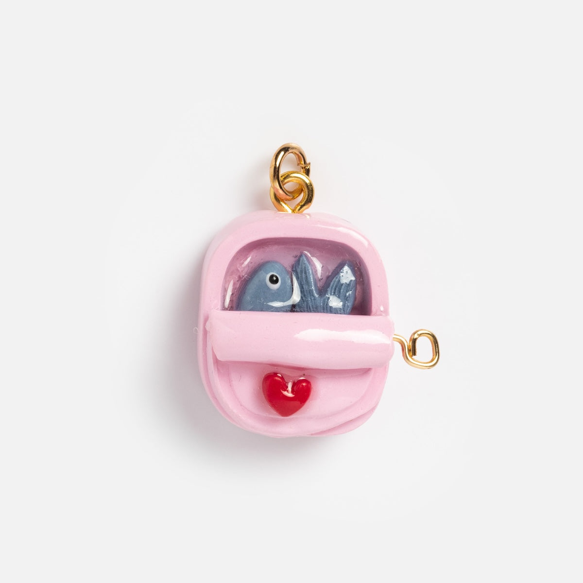 Charms by Warm Clay Co: A small pink gold-plated clay backpack charm with a gold loop, decorated with two blue fish and a red heart—an ideal unique accessory for necklace lovers.