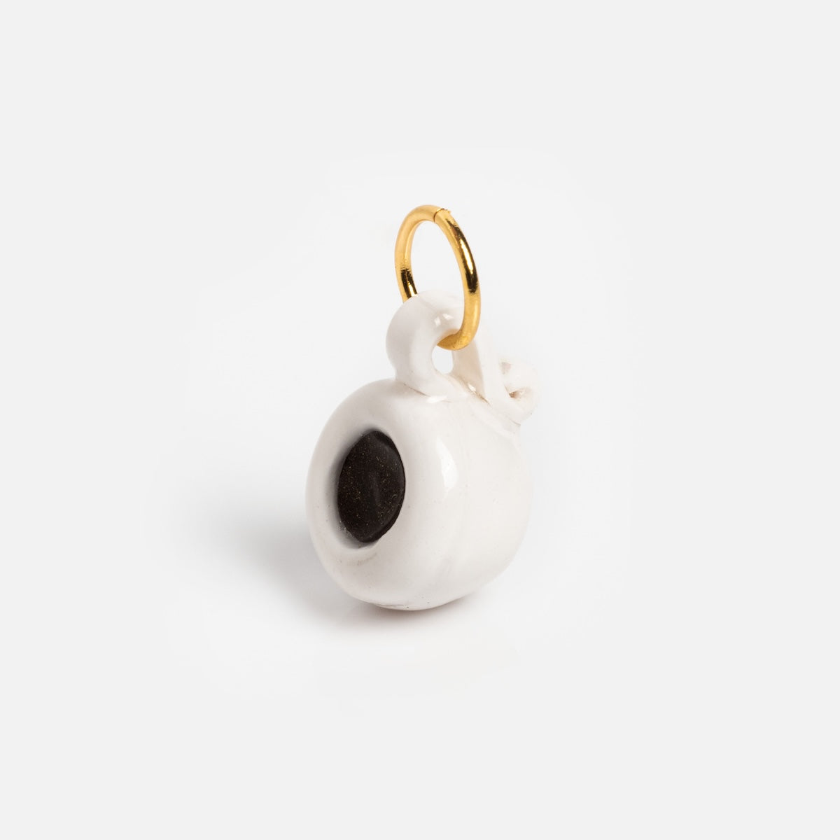 Charms by Warm Clay Co features a hand-crafted small white ceramic coffee cup charm with black coffee detail and a gold loop for jewelry. Ideal as a unique necklace accent, it’s displayed on a plain white background.