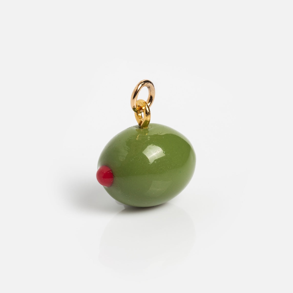 Charms by Warm Clay Co: A realistic, hand-crafted green olive charm with red pimento and a small gold loop for attaching to jewelry—ideal for adding unique touches to your necklace collection. Shown on a plain white background.