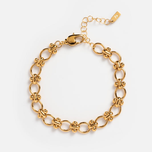 Aubrey Bracelet: A 14k gold bracelet with interlocking oval links, accented by round beads, finished with a lobster clasp and an adjustable extension chain featuring a delicate end tag.